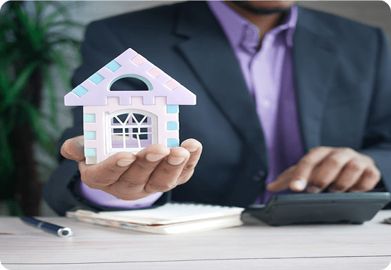 Person holding a small house model